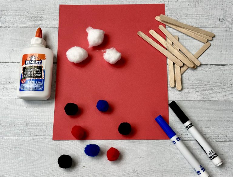 the materials needed to make the train craft, including craft sticks, construction paper, markers, glue, cotton balls, and pom poms