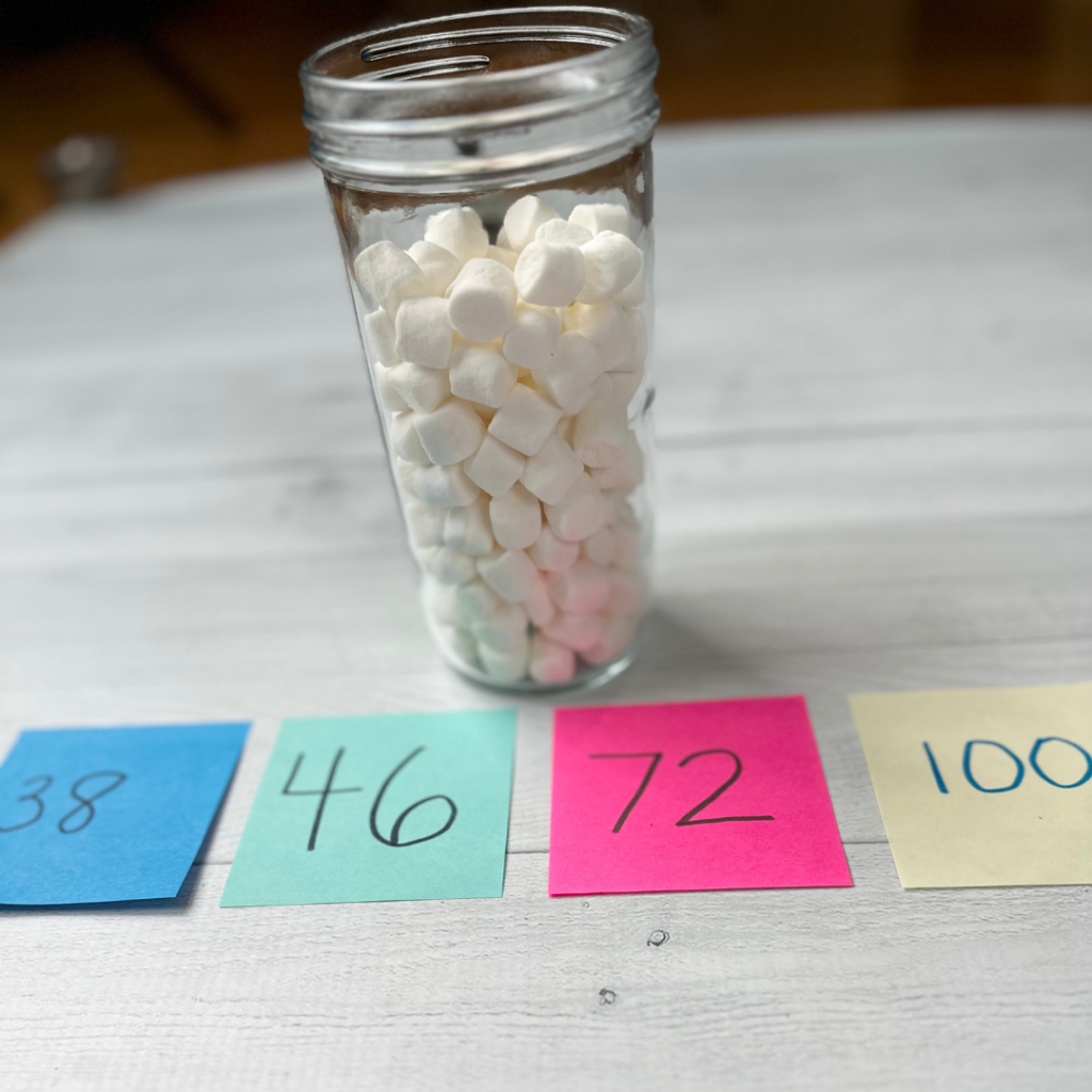 jar filled with marshmallows and numbers on sticky notes